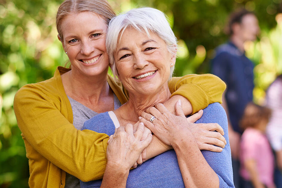 Heart Wellness PreCardix® - A smiling mother and daughter posing together outdoors at a park.